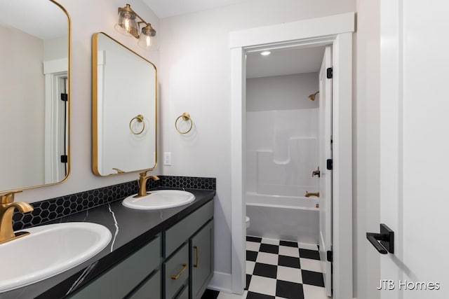 full bathroom with double vanity, a sink, toilet, and tile patterned floors