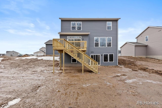 back of property featuring stairs and a wooden deck