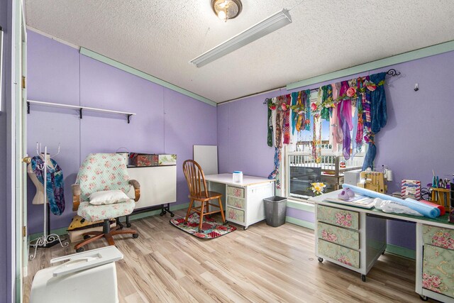 office space with light wood-type flooring and a textured ceiling