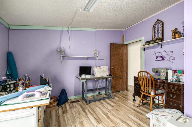 office area with wood-type flooring and a textured ceiling