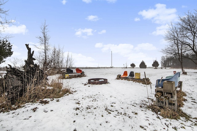 yard layered in snow featuring a fire pit