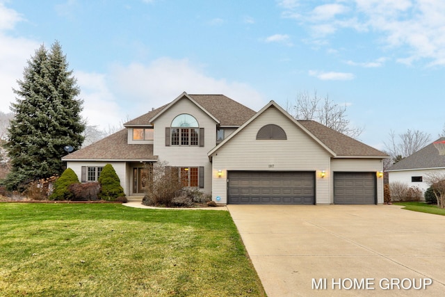 view of front property with a garage and a front yard