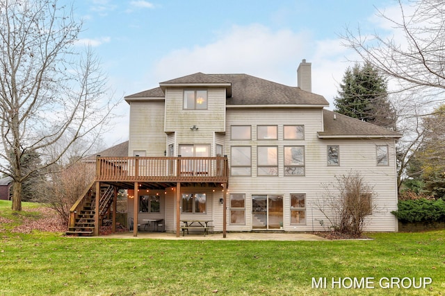 back of house featuring a yard, a patio area, and a wooden deck