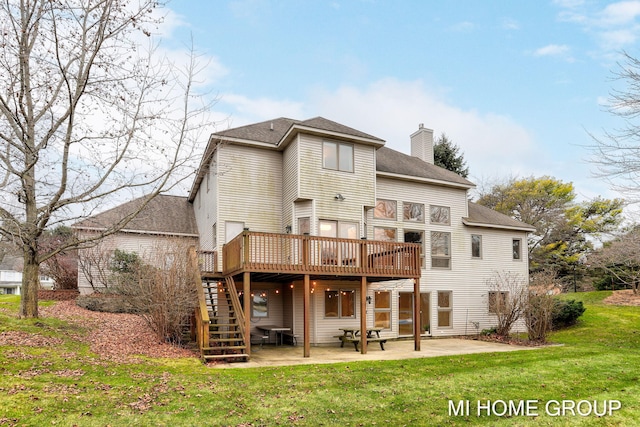 rear view of property with a yard, a patio, and a wooden deck