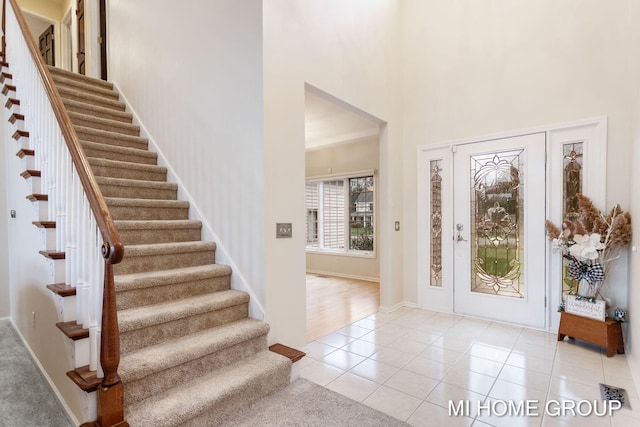 tiled foyer with a high ceiling