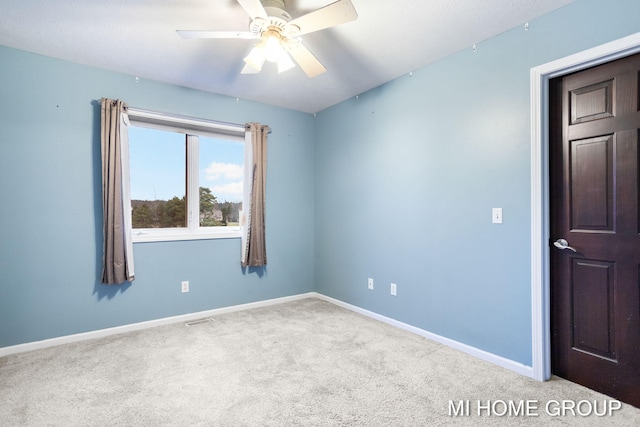 empty room featuring carpet and ceiling fan