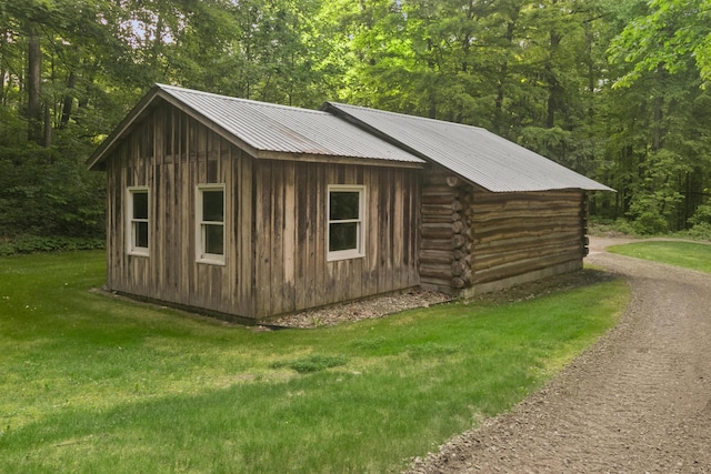 view of outbuilding with a lawn