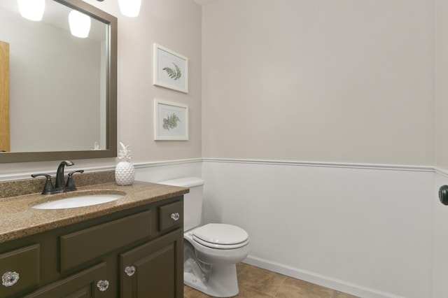 bathroom featuring tile patterned floors, vanity, and toilet