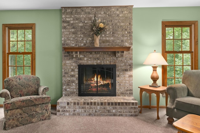 living area featuring carpet floors and a fireplace