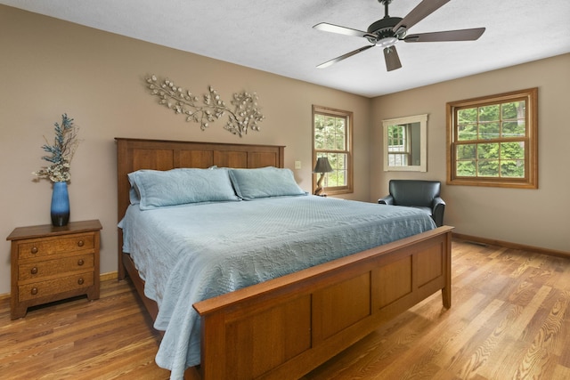 bedroom with hardwood / wood-style flooring and ceiling fan