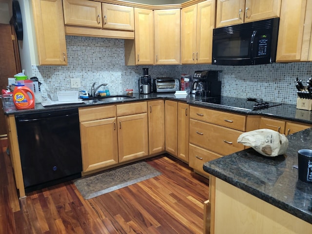 kitchen featuring backsplash, dark hardwood / wood-style flooring, black appliances, and sink