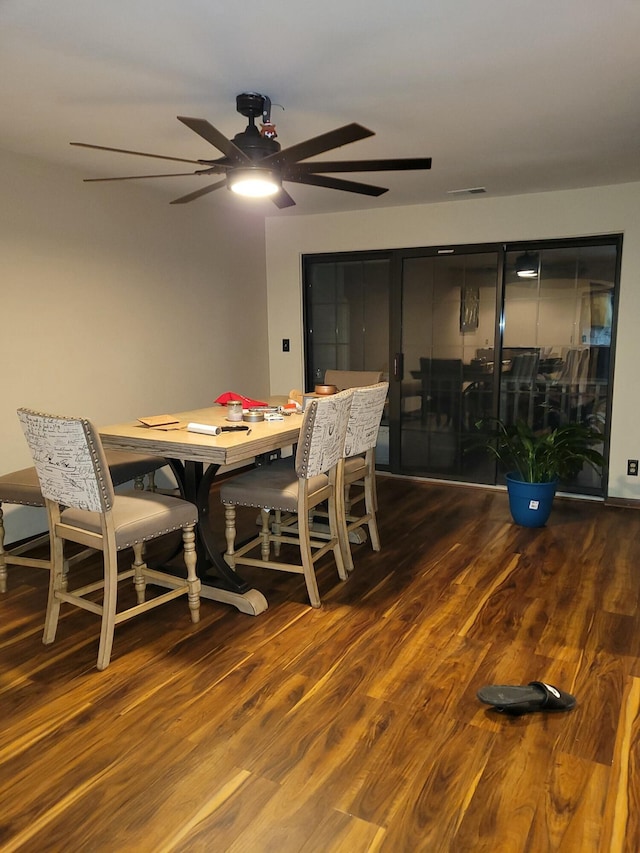 dining space with dark hardwood / wood-style flooring and ceiling fan