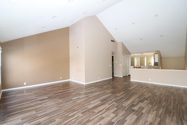 unfurnished living room featuring wood-type flooring and lofted ceiling