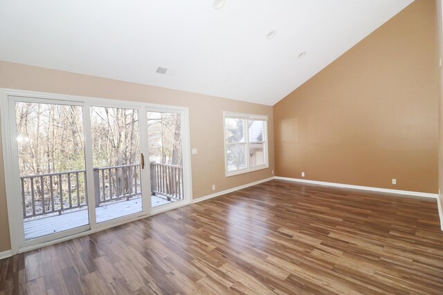 empty room featuring wood-type flooring and vaulted ceiling