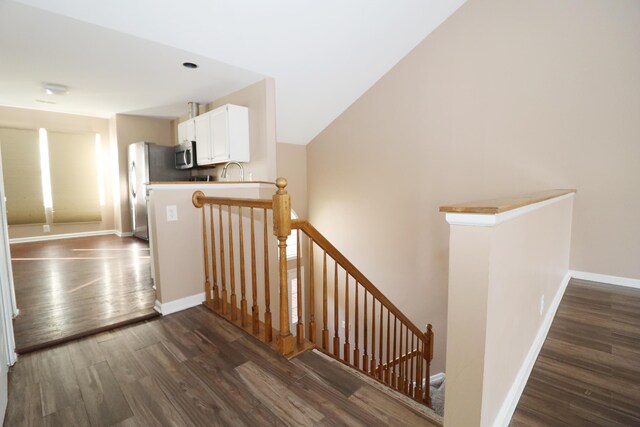 stairs with sink and wood-type flooring