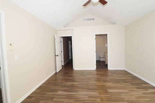 unfurnished bedroom with ceiling fan, dark hardwood / wood-style flooring, lofted ceiling, and connected bathroom