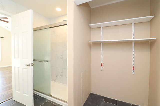 bathroom featuring a shower with door and tile patterned flooring