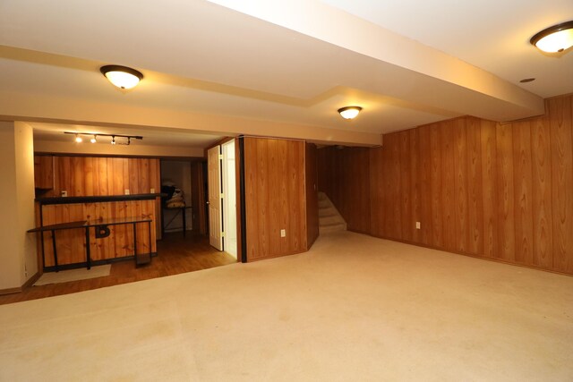 basement with dark colored carpet and wooden walls