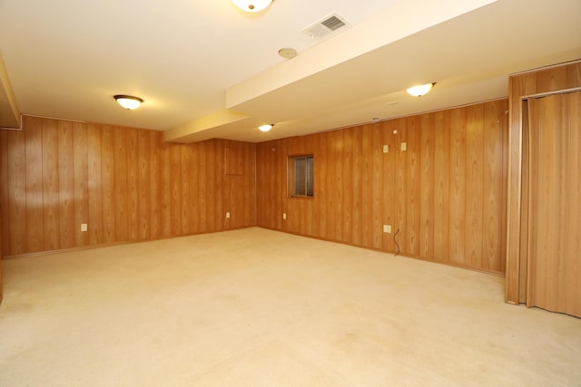 basement featuring carpet floors and wooden walls