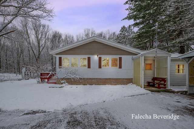 view of front of home with a storage shed