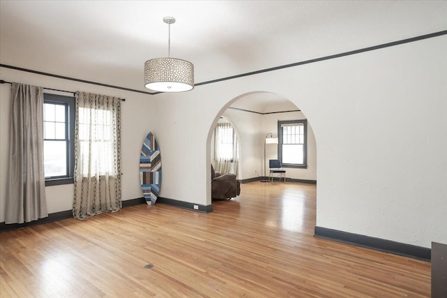 unfurnished room with a healthy amount of sunlight and light wood-type flooring