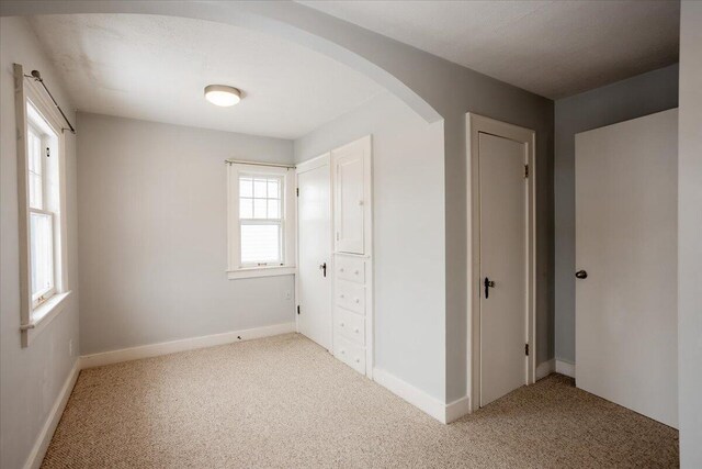 unfurnished bedroom with light colored carpet