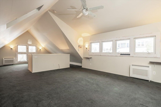 bonus room with dark colored carpet, lofted ceiling, ceiling fan, and an AC wall unit