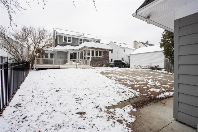 view of snow covered rear of property