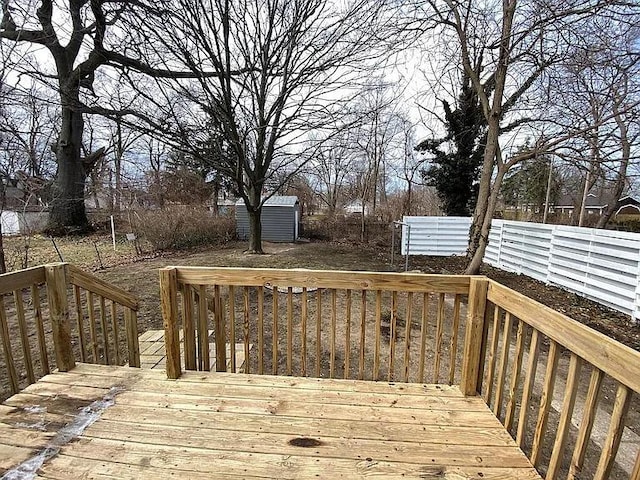 wooden deck featuring a storage shed