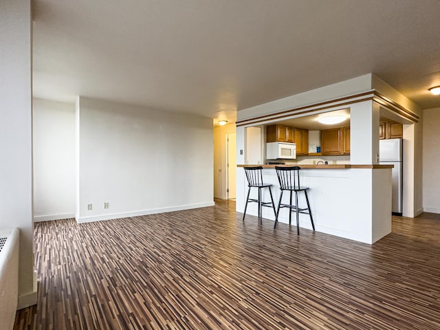 unfurnished living room featuring dark hardwood / wood-style floors