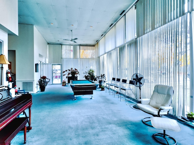 game room featuring carpet flooring, ceiling fan, expansive windows, and billiards