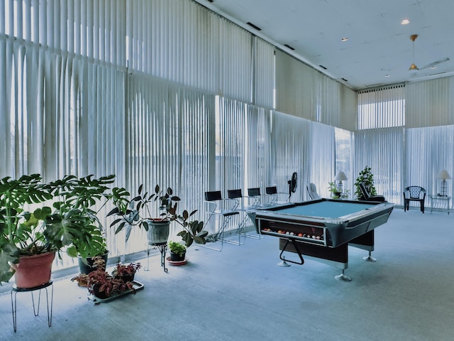 game room featuring a high ceiling, light colored carpet, and pool table