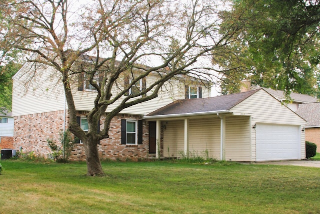 view of front of property featuring a garage and a front lawn