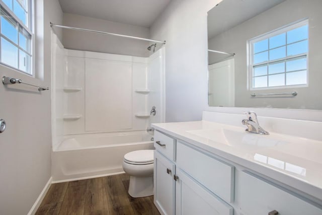 full bathroom with vanity, shower / bath combination, hardwood / wood-style flooring, and toilet