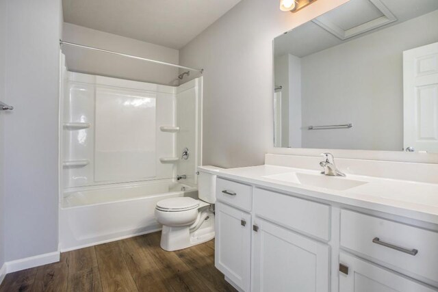 full bathroom with hardwood / wood-style floors, vanity, toilet, and shower / bath combination