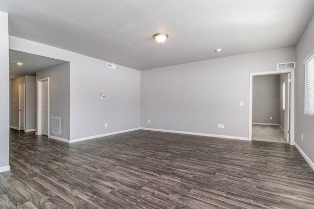 spare room featuring dark wood-type flooring