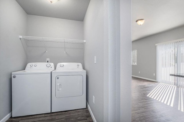 laundry room with washer and clothes dryer and dark hardwood / wood-style floors