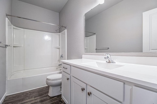 full bathroom with hardwood / wood-style flooring, vanity, toilet, and shower / tub combination