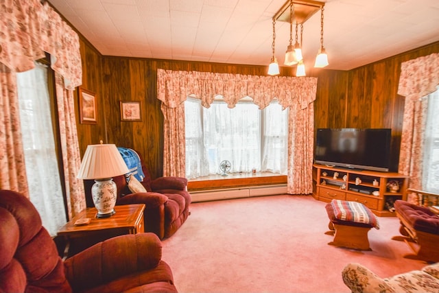 carpeted living room with wood walls and a baseboard heating unit