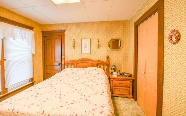 bedroom with light carpet and a closet