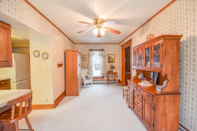 interior space featuring baseboard heating, crown molding, ceiling fan, and light colored carpet