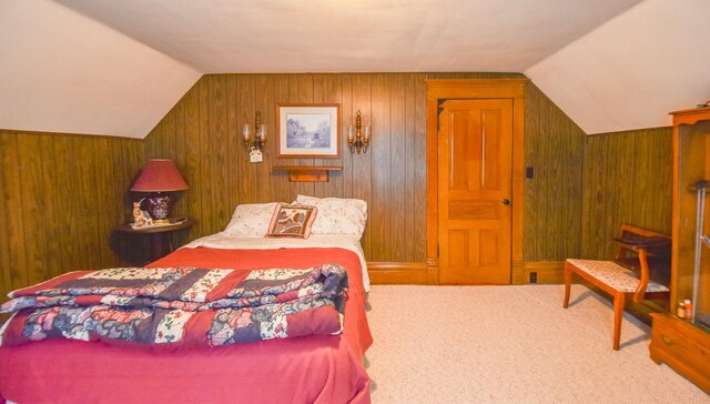 carpeted bedroom with wood walls and lofted ceiling