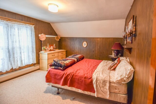 bedroom featuring wood walls, carpet floors, a baseboard heating unit, and vaulted ceiling