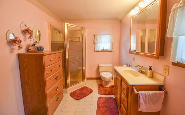 bathroom featuring vanity, toilet, and an enclosed shower