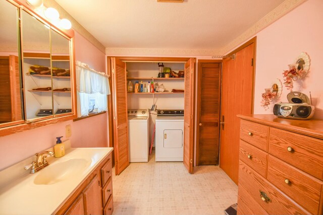 bathroom with separate washer and dryer and vanity