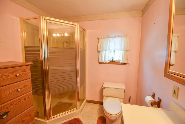 bathroom featuring toilet, an enclosed shower, and vanity