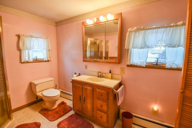 bathroom with vanity, toilet, walk in shower, and a baseboard heating unit