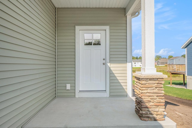 view of exterior entry featuring a patio area