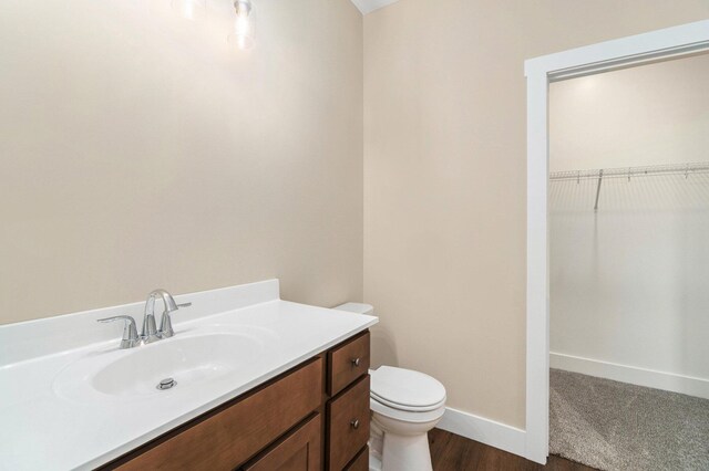 bathroom featuring vanity, toilet, and wood-type flooring