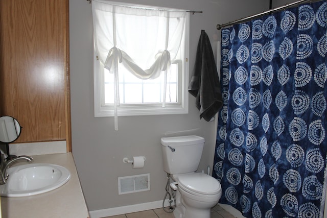 bathroom featuring toilet, tile patterned floors, and vanity